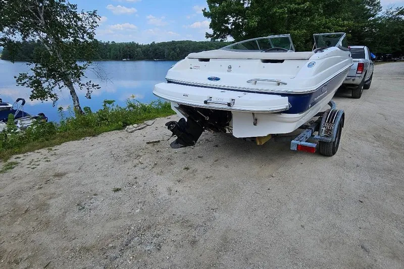 Slide: The Image of 2006 Chaparral 190 SSi boat on trailer by a serene lake. - 2