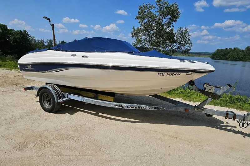 Slide: The Image of Chaparral 190 SSi 2006 boat on trailer by a lake under blue sky. - 4