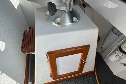 Slide: The Image of Open storage compartment on a 1987 Holland 32 boat, containing various items. - 22