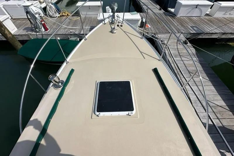 Slide: The Image of 1987 Holland 32 boat deck with hatch and winch in marina setting. - 25