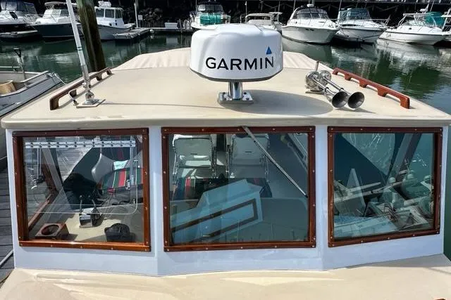 Slide: The Image of 1987 Holland 32 boat docked in a marina with surrounding vessels. - 27