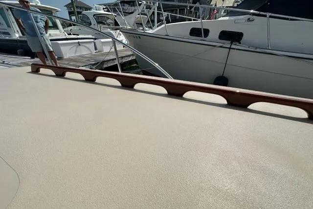 Slide: The Image of 1987 Holland 32 boat deck with marina view, featuring yachts and coastal buildings. - 30