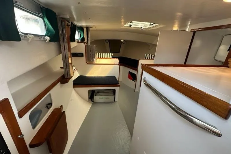 Slide: The Image of Interior of a 1987 Holland 32 boat with seating and storage areas. - 34