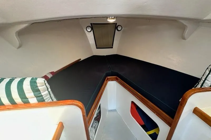Slide: The Image of Interior of 1987 Holland 32 boat with striped cushions and compact kitchen area. - 37
