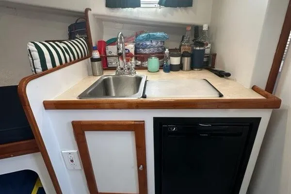 Slide: The Image of Interior of a 1987 Holland 32 boat with wooden accents and seating area. - 40