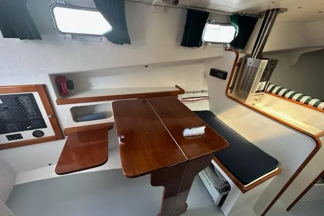 Slide: The Image of Interior of a 1987 Holland 32 boat with wooden furnishings and compact design. - 43