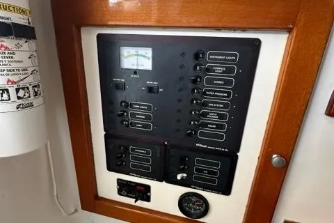 Slide: The Image of Electrical panel with AC master breaker and cabin lights switches, Holland 32, 1987 model. - 47