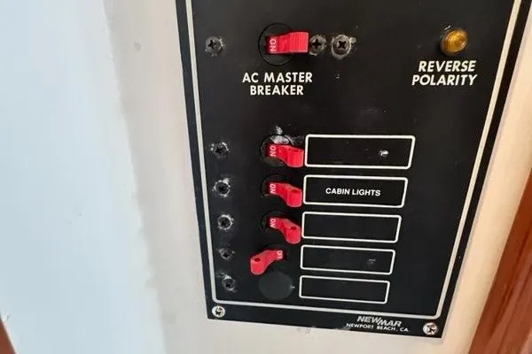 Slide: The Image of Open storage compartment on a 1987 Holland 32 boat, containing various items. - 48