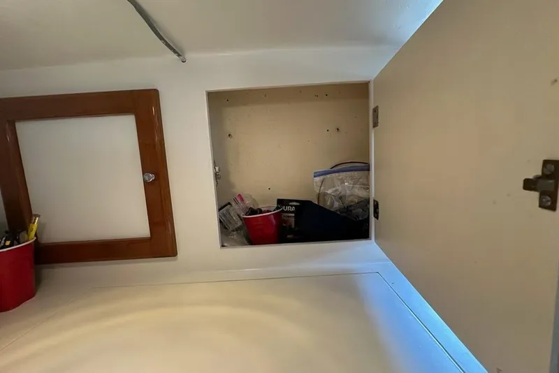 Slide: The Image of Engine compartment of a 1987 Holland 32 boat, showcasing a green marine engine. - 49