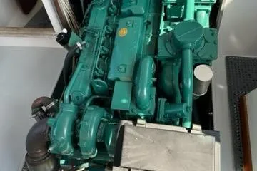 Slide: The Image of 1987 Holland 32 engine, green, detailed view in a boat compartment. - 51