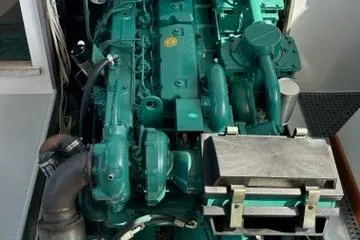 Slide: The Image of Engine compartment of a 1987 Holland 32 boat, showcasing mechanical components and wiring. - 52