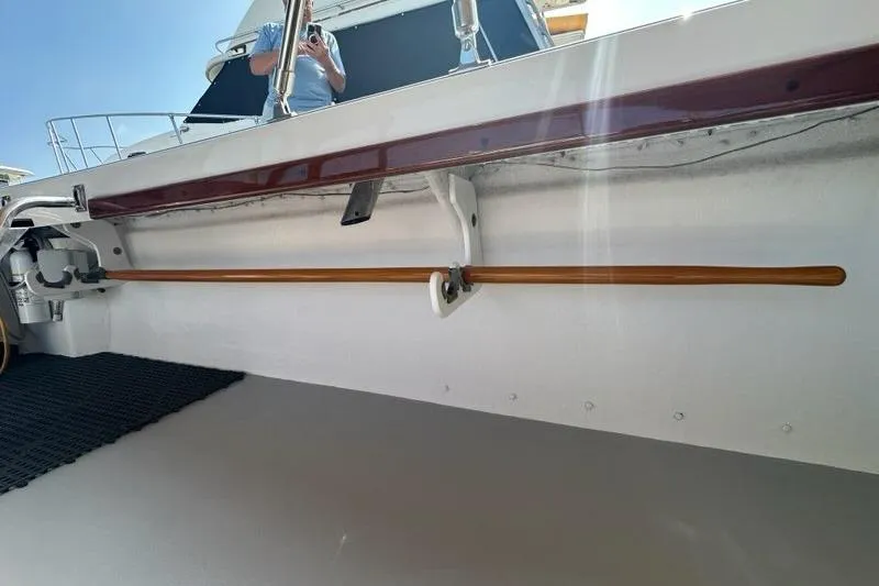 Slide: The Image of 1987 Holland 32 boat deck with wooden railings and marina view. - 57