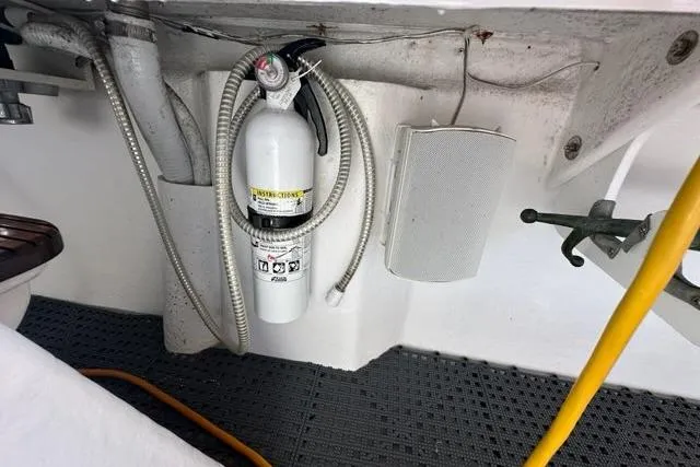 Slide: The Image of 1987 Holland 32 boat power connection with orange cable and water outlet. - 60