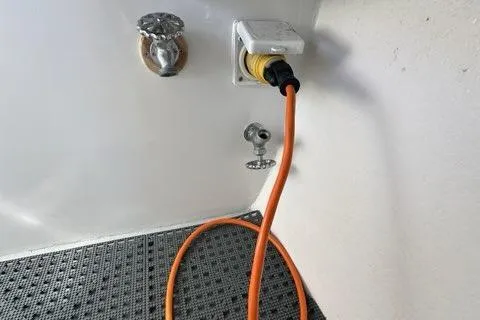 Slide: The Image of Striped cushion on a 1987 Holland 32 boat, featuring vibrant red, green, and blue colors. - 61