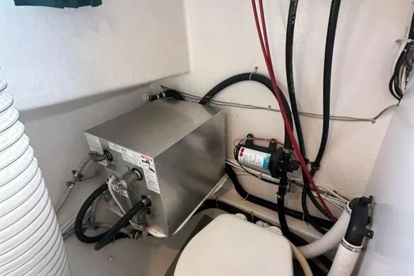 Slide: The Image of Interior view of a 1987 Holland 32 boat showing plumbing and electrical components. - 64