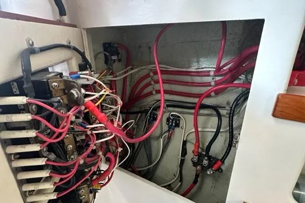 Slide: The Image of 1987 Holland 32 boat with striped chairs under a canopy, docked by the water. - 66