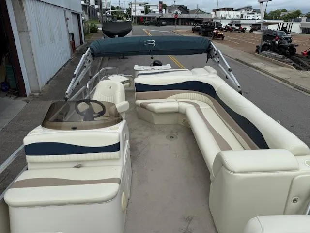 Slide: The Image of 2008 Bennington 2277FSi pontoon boat with spacious seating and canopy, parked on a street. - 10
