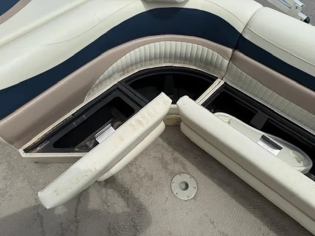 Slide: The Image of 2008 Bennington 2277FSi boat interior with open storage compartments and cushioned seating. - 16