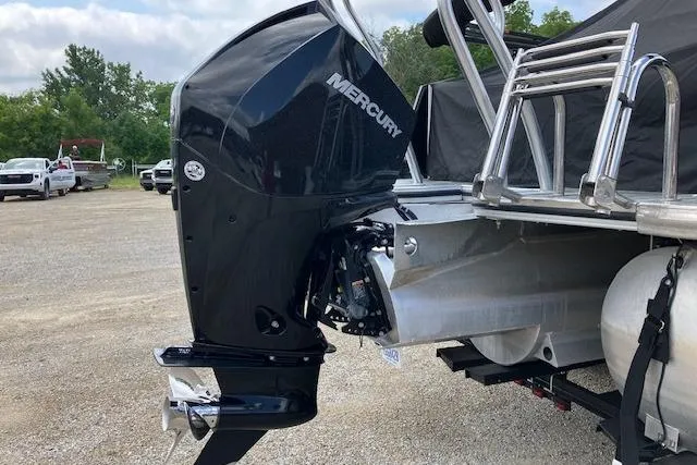 Slide: The Image of 2020 Crest Caribbean RS 250 SLS boat with Mercury outboard motor, parked on gravel. - 10