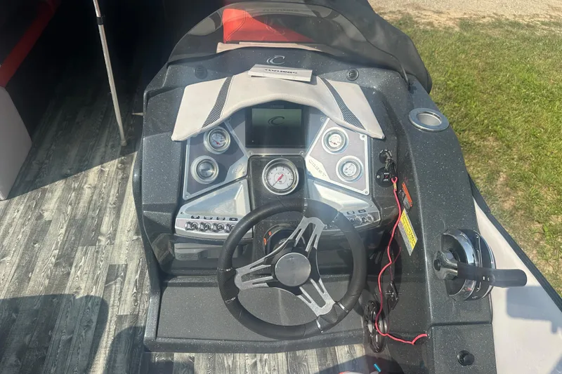 Slide: The Image of 2020 Crest Caribbean RS 250 SLS boat dashboard with steering wheel and control panel. - 12