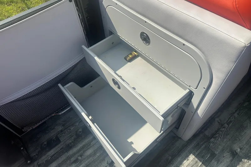 Slide: The Image of Open storage drawers in a 2020 Crest Caribbean RS 250 SLS boat interior. - 16