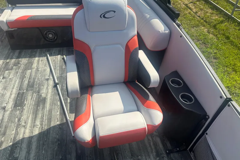 Slide: The Image of Captain's chair on 2020 Crest Caribbean RS 250 SLS boat with red accents and cup holders. - 18
