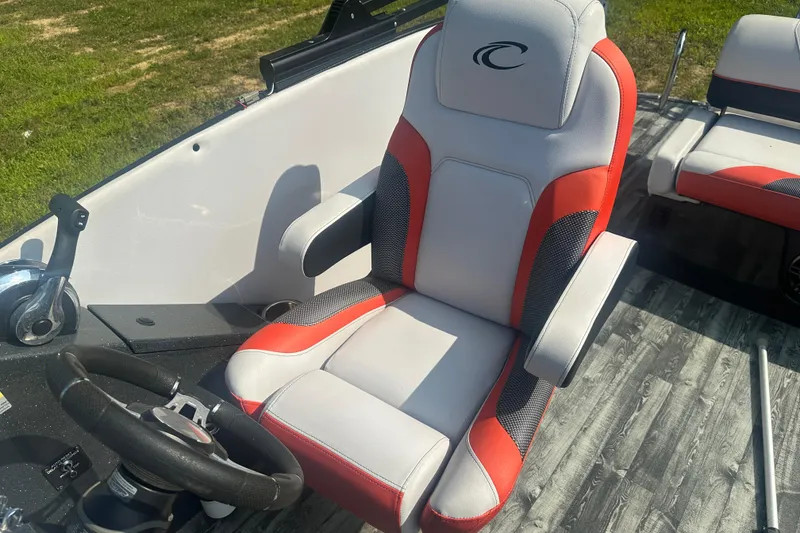 Slide: The Image of Captain's seat in 2020 Crest Caribbean RS 250 SLS boat, featuring red and gray upholstery. - 20