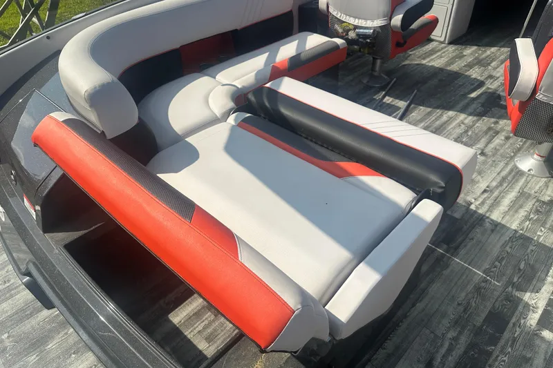Slide: The Image of 2020 Crest Caribbean RS 250 SLS boat interior with red and gray seating. - 26