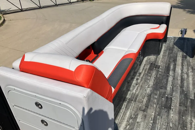 Slide: The Image of 2020 Crest Caribbean RS 250 SLS boat interior with red and white seating, wood-style flooring. - 8