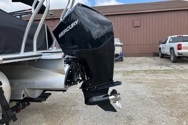 Slide: The Image of 2020 Crest Caribbean RS 250 SLS with Mercury outboard motor in a parking area. - 9