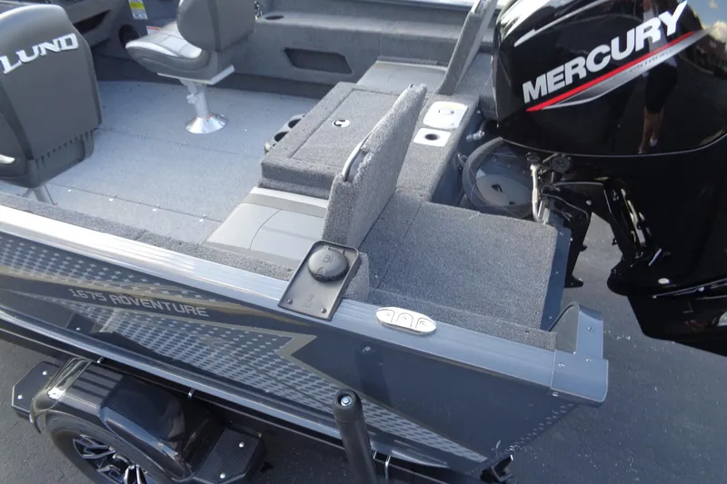 Slide: The Image of 2025 Lund 1675 Adventure SS boat interior with Mercury engine, featuring seating and storage. - 12