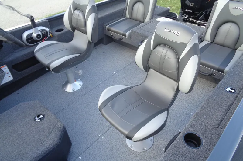 Slide: The Image of 2025 Lund 1675 Adventure SS boat interior with gray seating and steering console. - 14