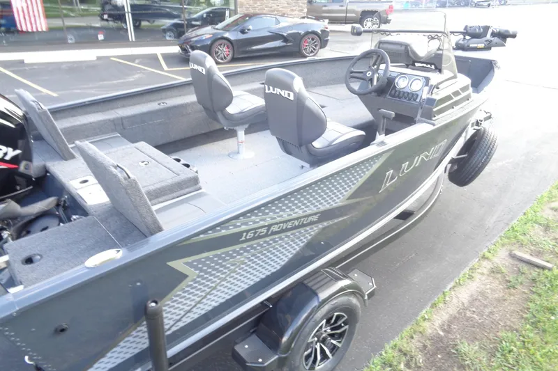 Slide: The Image of 2025 Lund 1675 Adventure SS boat with sleek design and modern features, parked outdoors. - 15
