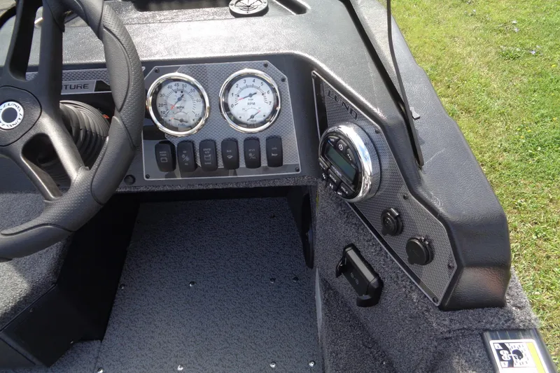 Slide: The Image of 2025 Lund 1675 Adventure SS dashboard with gauges and controls, featuring a sleek steering wheel. - 19