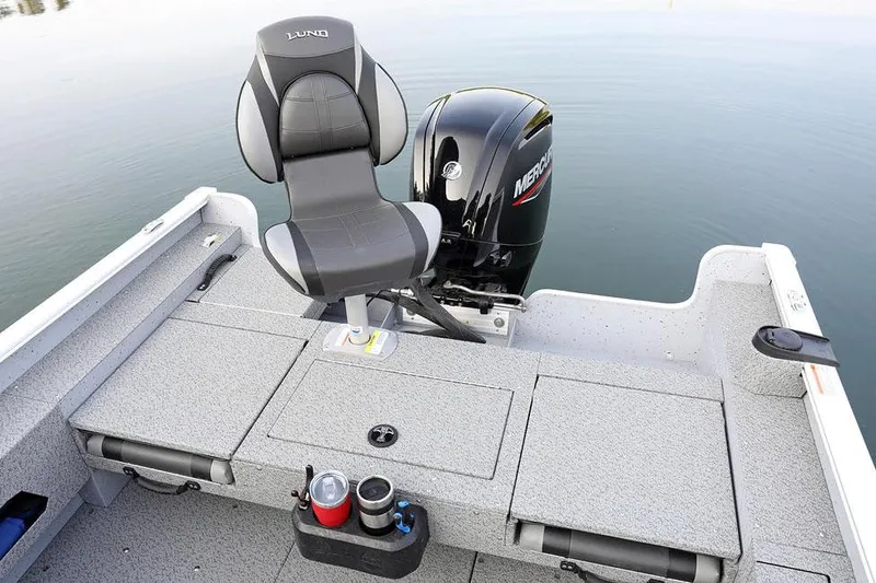 Slide: The Image of Manufacturer Provided Image: 2025 Lund 1675 Adventure SS boat interior with Mercury engine, featuring a comfortable seat and storage. - 27