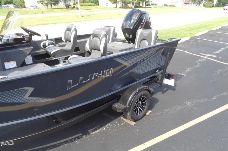 Slide: The Image of 2025 Lund 1675 Adventure SS boat on trailer, parked in a lot. - 3
