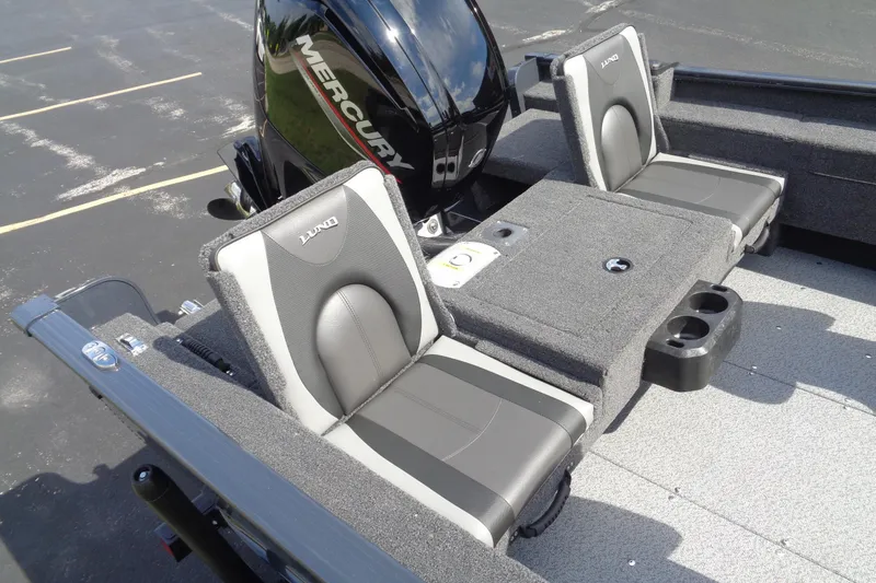 Slide: The Image of 2025 Lund 1675 Adventure SS boat seats with Mercury engine, featuring gray and black upholstery. - 7