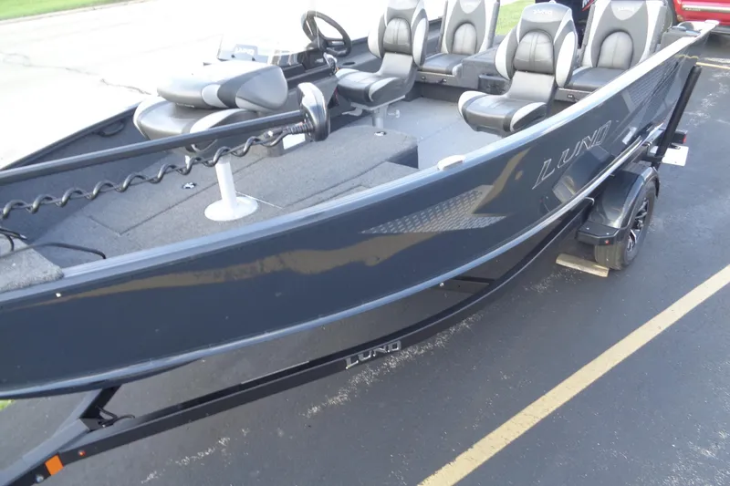 Slide: The Image of 2025 Lund 1675 Adventure SS boat with seating and sleek design on a trailer. - 8