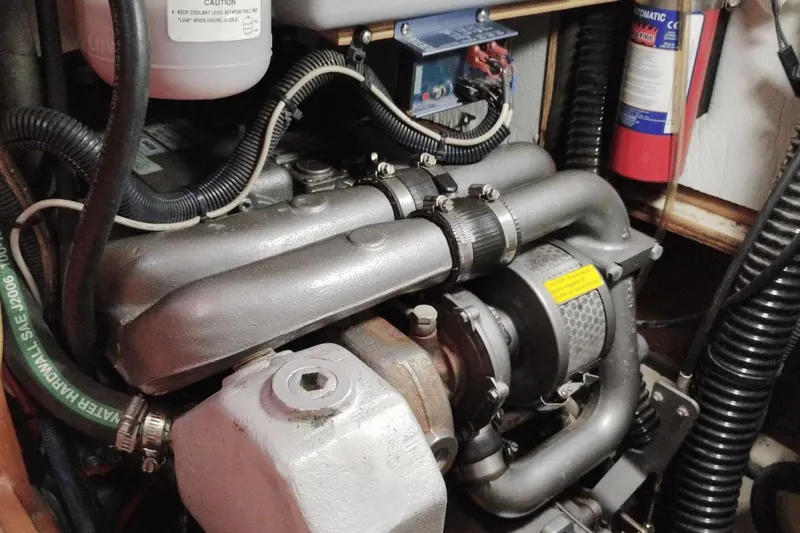 Slide: The Image of Engine compartment of 2009 Hunter 50 Center Cockpit sailboat, showing detailed components. - 13