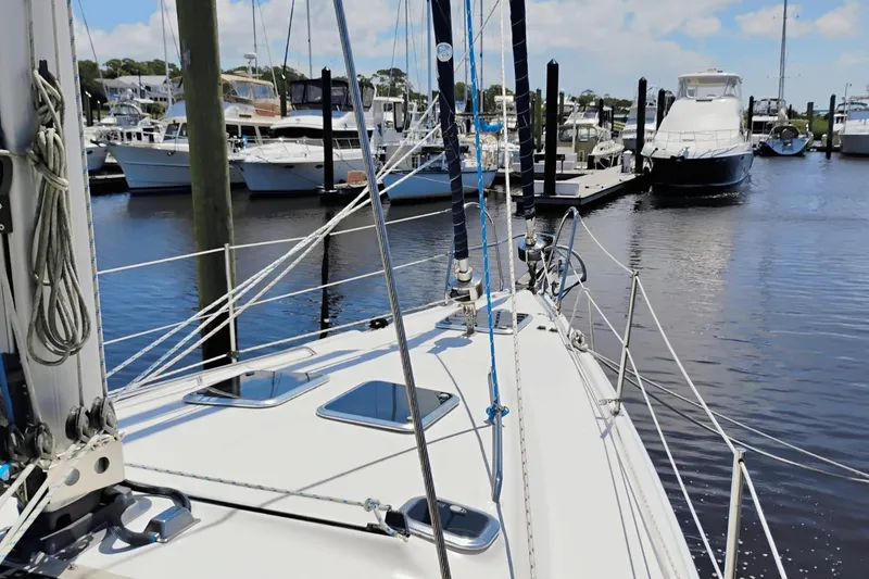 Slide: The Image of 2009 Hunter 50 Center Cockpit sailboat docked in a marina, surrounded by other boats. - 2
