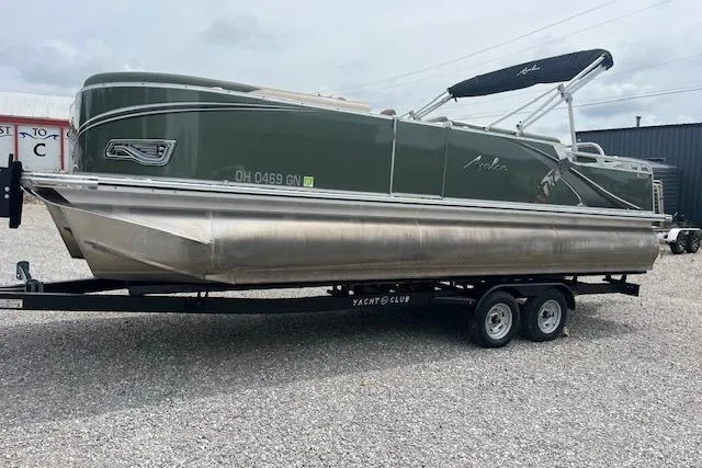 The Image of 2024 Avalon Platinum LSZ 2385 Elite pontoon boat on trailer, parked outdoors. - 0