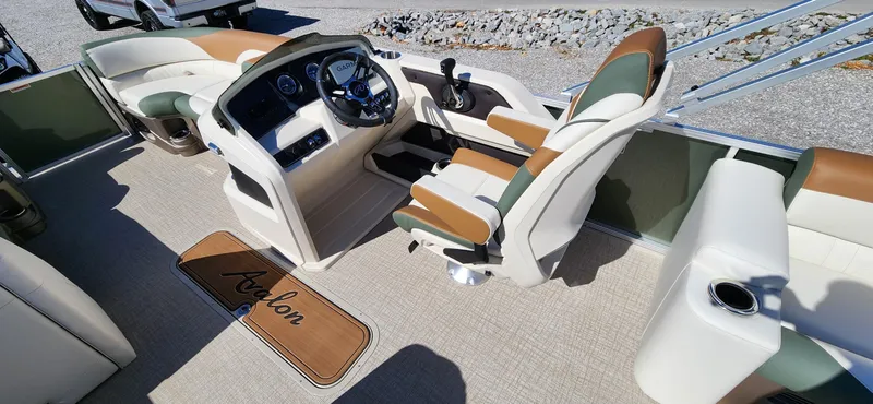Slide: The Image of 2024 Avalon Platinum LSZ 2385 Elite boat interior with luxurious seating and modern dashboard. - 13