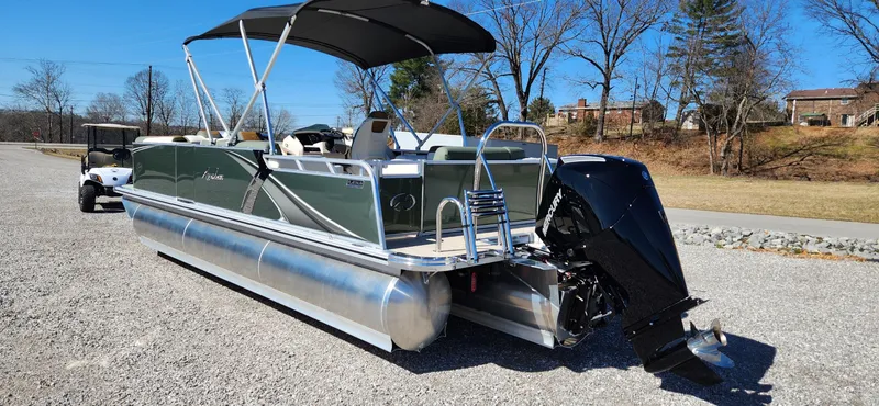 Slide: The Image of 2024 Avalon Platinum LSZ 2385 Elite pontoon boat with canopy on gravel surface. - 8