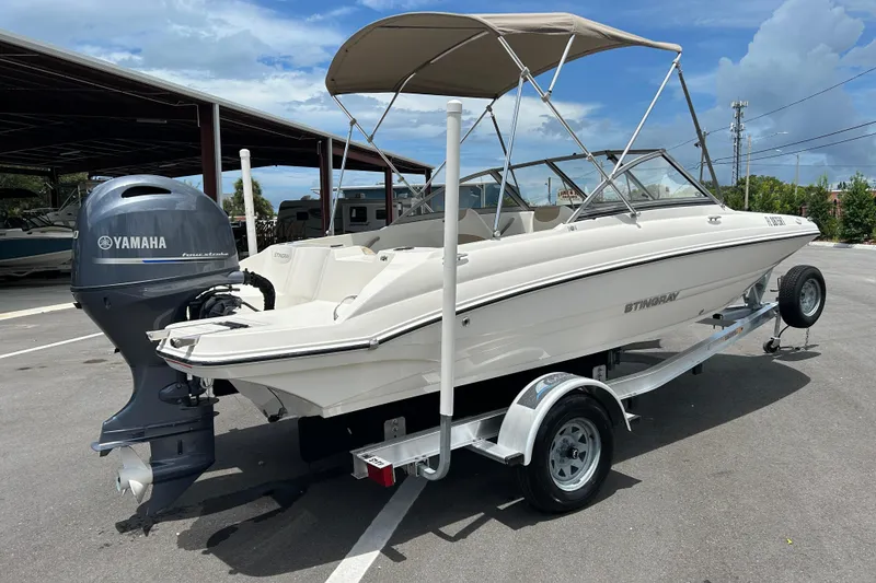 Slide: The Image of 2018 Stingray 191 DC boat with Yamaha outboard motor on trailer. - 1