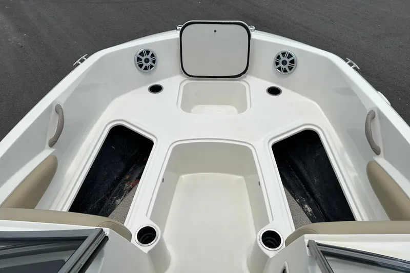 Slide: The Image of 2018 Stingray 191 DC boat interior with storage compartments and speakers. - 13