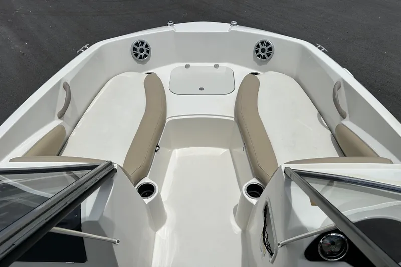 Slide: The Image of 2018 Stingray 191 DC boat interior with beige seating and cup holders. - 7