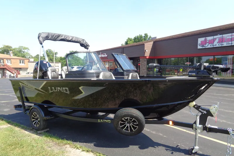 The Image of 2025 Lund 1775 Adventure Sport boat on trailer in parking lot. - 0