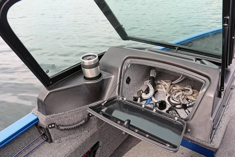 Slide: The Image of Manufacturer Provided Image: 2025 Lund 1775 Adventure Sport boat interior with open storage compartment and cup holder. - 14