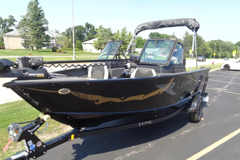 Slide: The Image of 2025 Lund 1775 Adventure Sport boat on trailer, parked outdoors. - 3