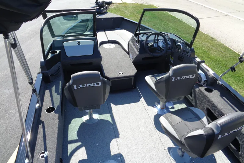 Slide: The Image of 2025 Lund 1775 Adventure Sport boat interior with seating and steering console. - 4